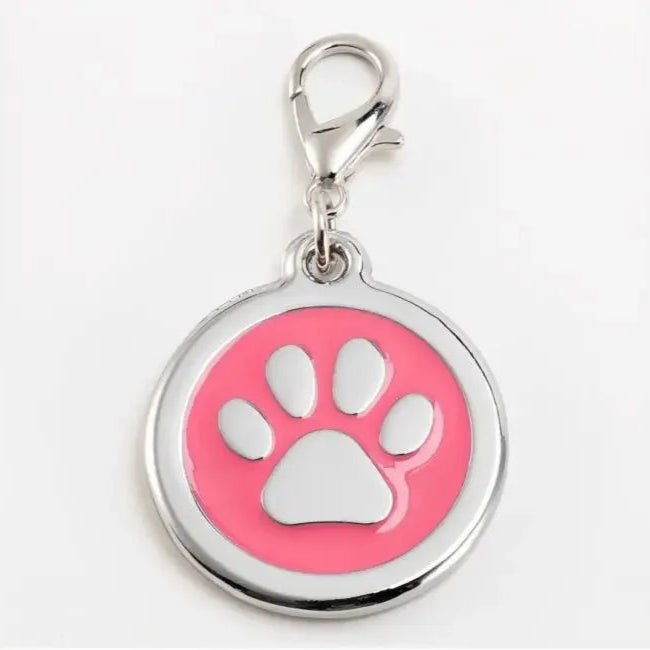Pink pet tag with a white paw print on a white background