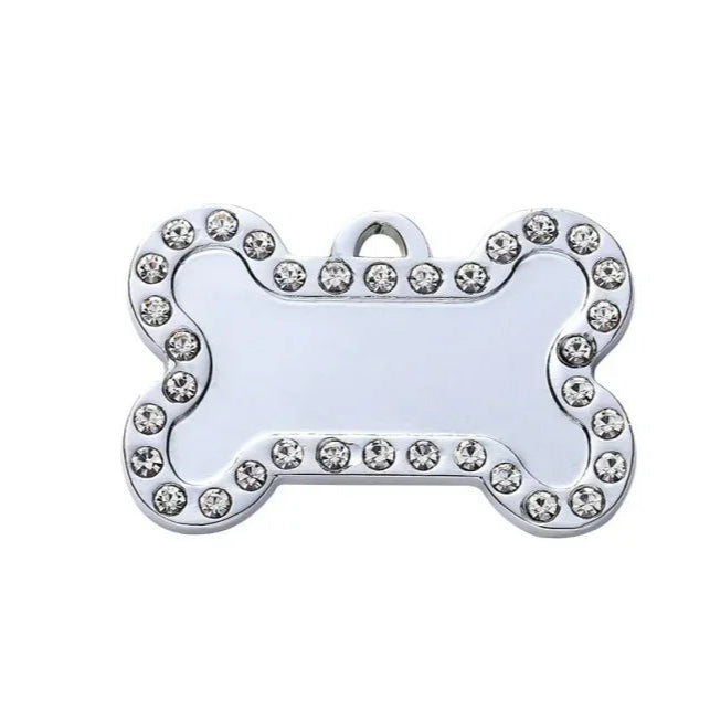 Dog bone-shaped tag with rhinestone border on a white background