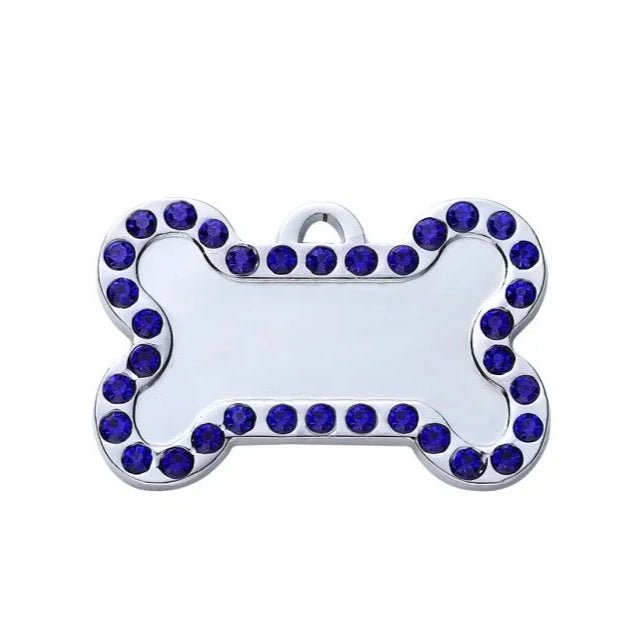 Dog tag with blue gemstones on a white background