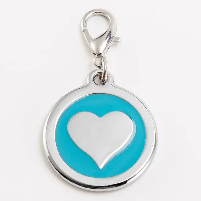 Heart-shaped pendant with blue background and silver frame on a white background