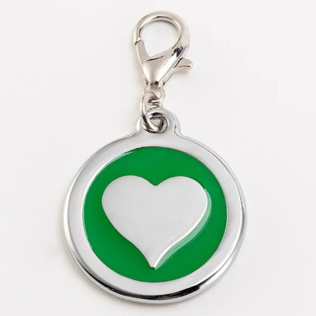 Green and silver heart-shaped pendant on a white background