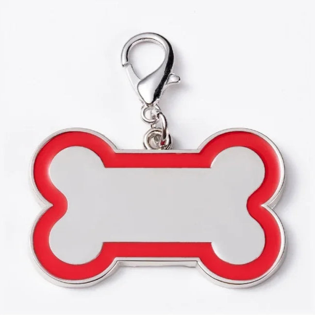 Red bone-shaped pet tag with a silver clip on a white background