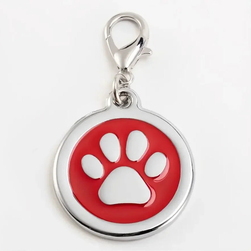 Red and silver pet tag with a paw print on a white background